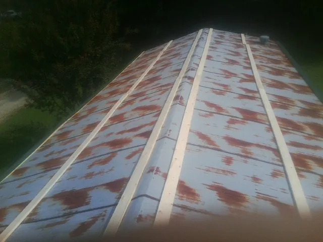 Rusted metal roof panels with new wood purlins before replacement — Storm Damage Roof Repair in East Chicago by Roofing Brothers